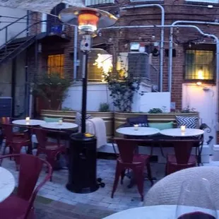 a patio with tables and chairs