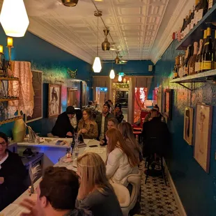 people sitting at a bar in a restaurant