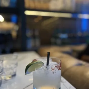 a margarita in a glass with a lime wedge