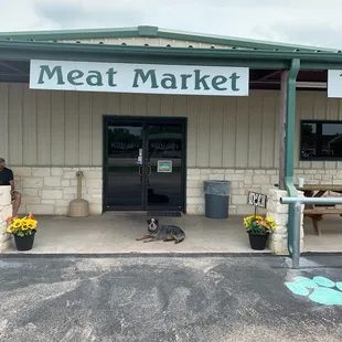 a man and his dog in front of the store