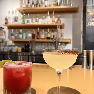 two cocktails on a bar