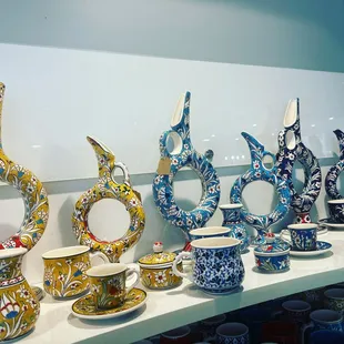 a variety of pottery items displayed on a shelf