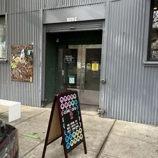 a sign in front of a coffee shop