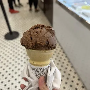 Chocolate brownie ice cream in kid&apos;s cone