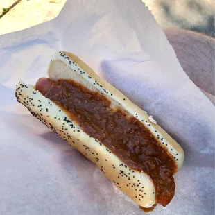 Chili cheese hot dog with shredded cheddar