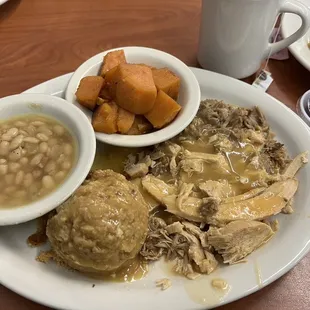 Turkey and dressing with navy beans, yams, and cranberry sauce on the side