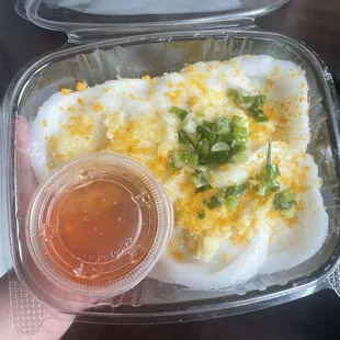 a person holding a container of food