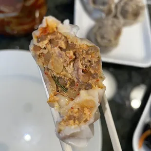 chopsticks holding food