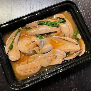 a chicken dish in a black container