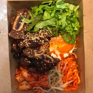 this is the galbi bibimbox. it was pretty good. the rice was interesting - it was like mixed in with the japchae or something