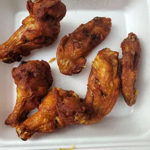 chicken wings and rice in a styrofoam container