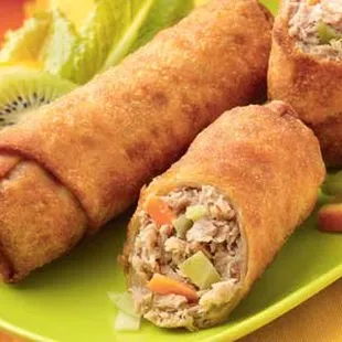 a green plate with three rolls of food