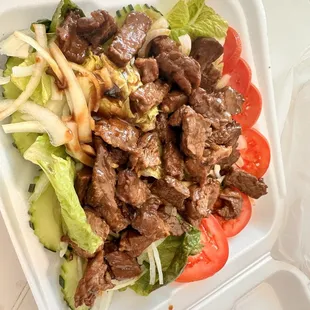 beef and vegetables in a styrofoam container
