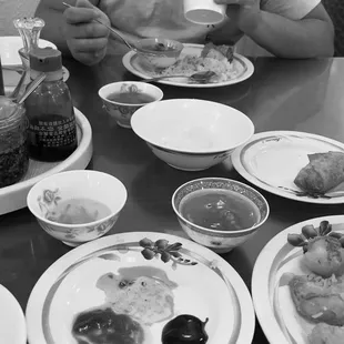 a black and white photo of a table full of food