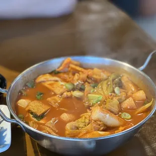a bowl of stew and a plate of salad