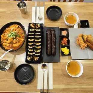 Tteokbokki with fried combo, shrimp tempura kimbap with sweet sauce, soondae (Korean stuffed sausage), and miso soup