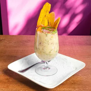 Leche de Tigre- Fresh lime juice cocktail, diced onion, and chunks of fish, Peruvian corn and sweet potato.