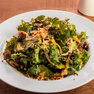 KK Salad- Kale Peruvian quinoa, thinly sliced red onion, grape, dried cranberries, caramelized walnuts, and feta.