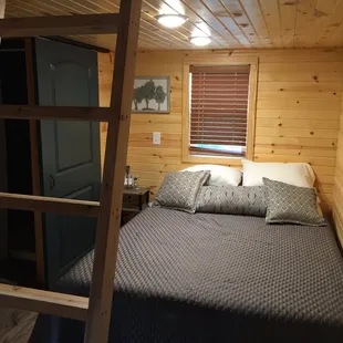 One of the two queen beds in The Homestead glamping cabin
