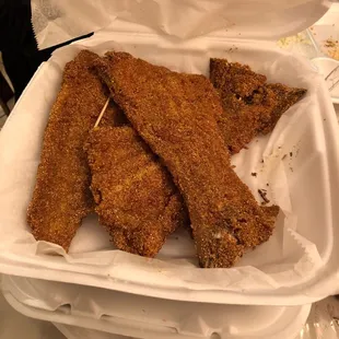 fried chicken strips in a styrofoam container