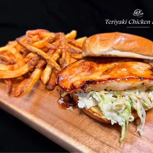 Teriyaki chicken, Asian pineapple slaw, on a Brioche bun with a side of fries.