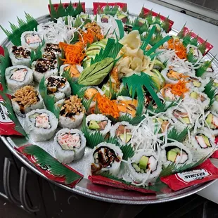 a platter of sushi and rolls