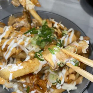 a plate of food with chopsticks