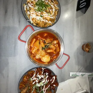 three bowls of food on a table