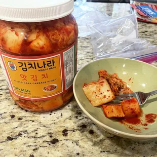 a bowl of kimchi and a jar of kimchi