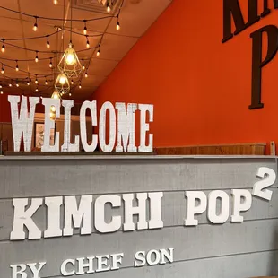 a sign for kimchi pop by chef son