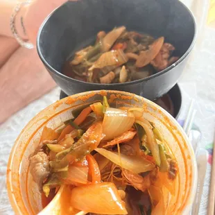 a bowl of kimchipoji and a bowl of stir fry