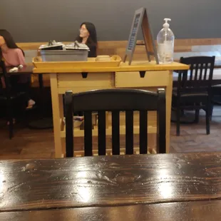 a woman sitting at a table in a restaurant