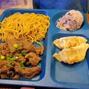 a blue tray of food on a wooden table