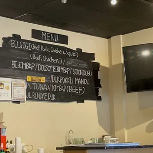 a menu on the wall of a restaurant