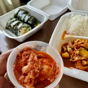 A side of Kimchee and background pictures are Kimbap w/tuna and fried tofu and Squid Bulgogi w/Jasmine rice