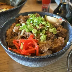 Beef over rice with pickled veggies and egg