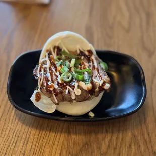 a black plate on a wooden table