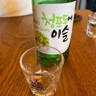 a bottle of wine and a shot glass