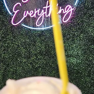 a hand holding a cup of ice cream