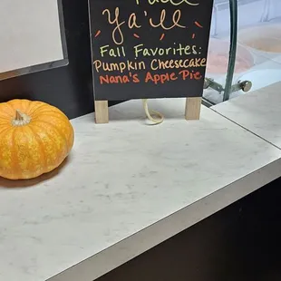 a pumpkin and a sign