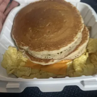 Pancakes and Eggs with a slice of Cheese on top