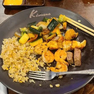 Steak, shrimp, lobster, fried rice and veggies