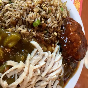 a plate of rice, meat, and vegetables