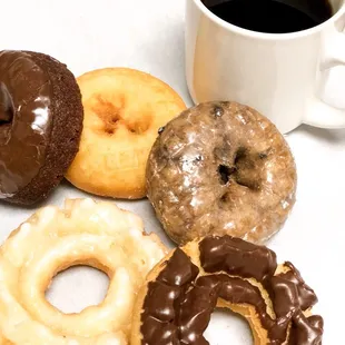 a variety of donuts and a cup of coffee