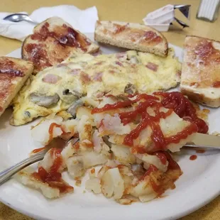 Ham, cheese and mushroom omelet, home fries and toast