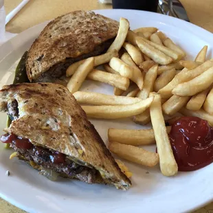 Beef patty melt with french fries.