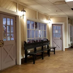 a hallway with a bench and a door