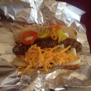 a hot dog with cheese and peppers