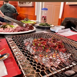 a man preparing food on a grill