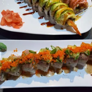 two plates of sushi with salmon and avocado